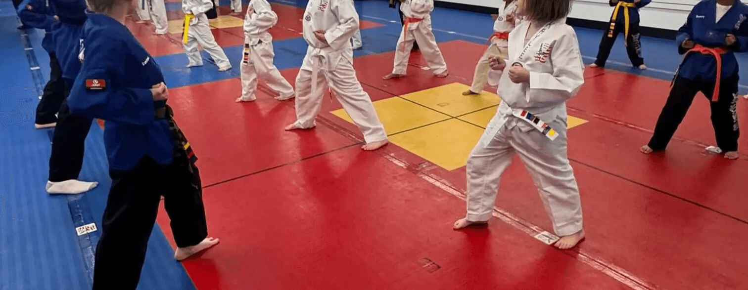 Kids martial arts students sparring in class