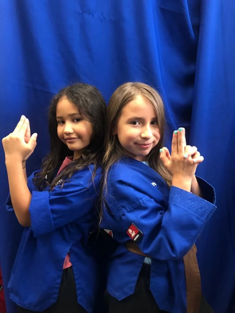 Two students giving a thumbs up