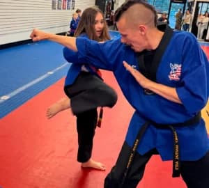 Teen and adult martial arts class on the mat